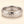 A white gold band mens wedding ring with a hammered texture on the exterior and a polished interior by ring bear with comfort fit, set against a solid cream background.