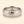 A white gold band mens wedding ring with a hammered texture on the exterior and a polished interior by ring bear with comfort fit, set against a solid cream background.