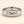 A white gold band mens wedding ring with a hammered texture on the exterior and a polished interior by ring bear with comfort fit, set against a solid cream background.